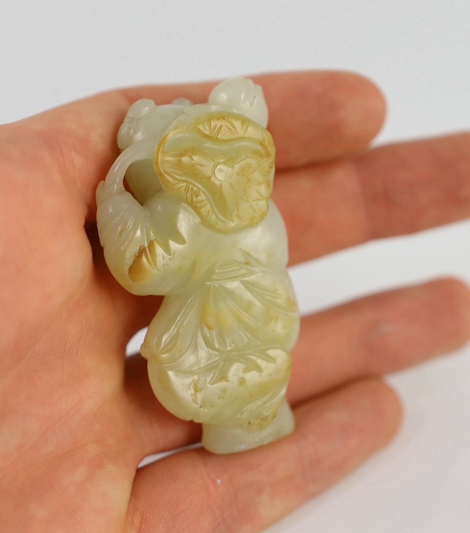 An assembled group of four Chinese pale celadon jade figures, 18th/19th century, displayed on two later wood 'rock-work' stands, total height approximately 19cm high